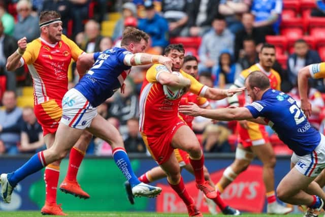 Wakefield's George King, right, and Danny Kirmond tackle Catalans Dragons' Matty Smith.