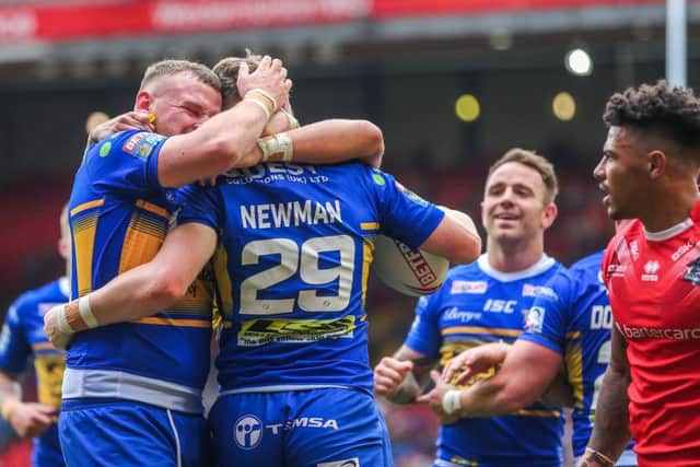 Harry Newman is congratulated on his try against London Broncos by Leeds Rhinos team-mate Brad Singleton. PIC: Alex Whitehead/SWpix.com