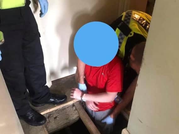 A wanted man was found hiding in a hole underneath his floorboards. Photo provided by the West Yorkshire Police Bradford West team.