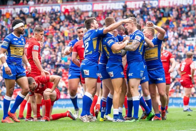 Leeds Rhinos players celebrate Liam Sutcliffe's try against London.