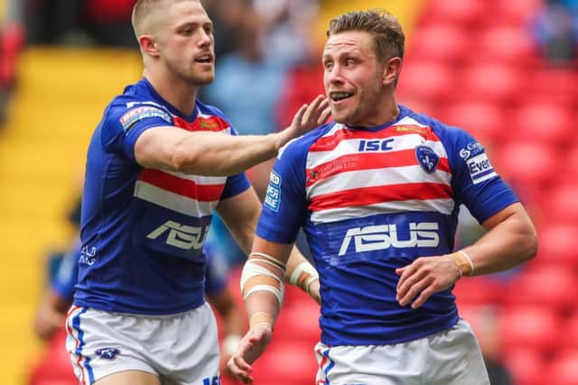 Wakefield's Kyle Wood celebrates his Magic Weekend try with Ryan Hampshire.