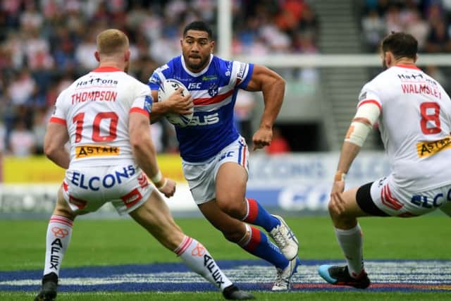 Wakefield's Kelepi Tanginoa takes on St Helens' Luke Thompson and Alex Walmsley.