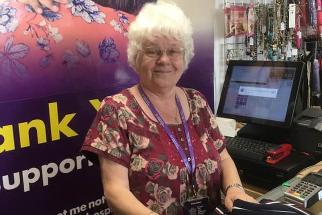 RETAIL: A volunteer who works in one of Forget Me Not shops, which helps support the charity.