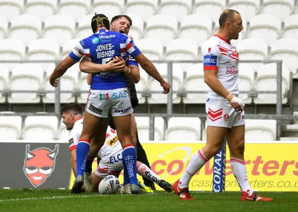 Wakefield's Jack Croft celebrates with Ben Jones-Bishop after scoring on his first team debut at St Helens.