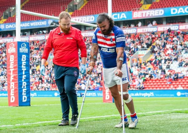 Wakefield's David Fifita is helped off the field at Anfield.