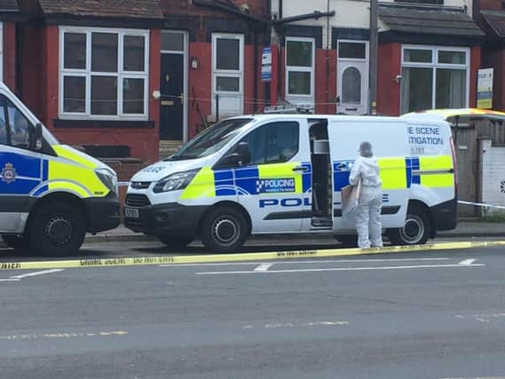 A police forensics officer at the scene in Compton Road.