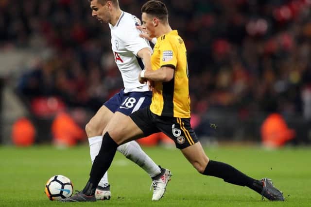 Ben White challenges Fernando Llorente during an FA Cup tie between Newport County and Tottenham Hotspur.