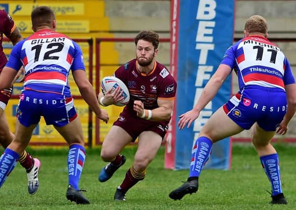 Batley's Dave Scott takes on Rochdale's Ellis Gilliam and Lee Mitchell.