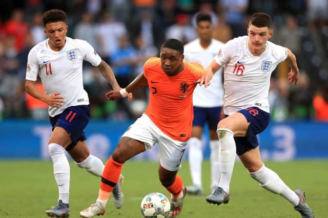 Netherlands' Steven Bergwijn (centre) gets away from England's Declan Rice (right) and Jadon Sancho in Guimaraes. Picture: Mike Egerton/PA