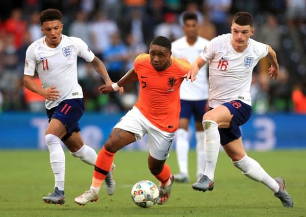 Netherlands' Steven Bergwijn (centre) gets away from England's Declan Rice (right) and Jadon Sancho in Guimaraes. Picture: Mike Egerton/PA