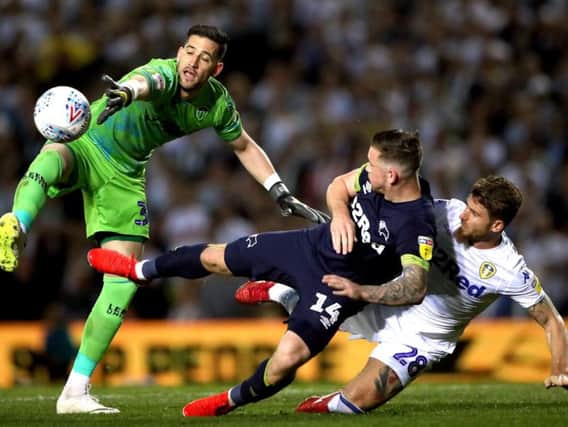 Kiko Casilla challenges Jack Marriott during Leeds United's play-off defeat to Derby County.