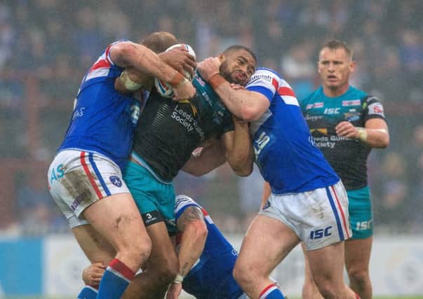 Halted: KallumWatkins is held by Wakefield's defence. 
Picture: Bruce Rollinson