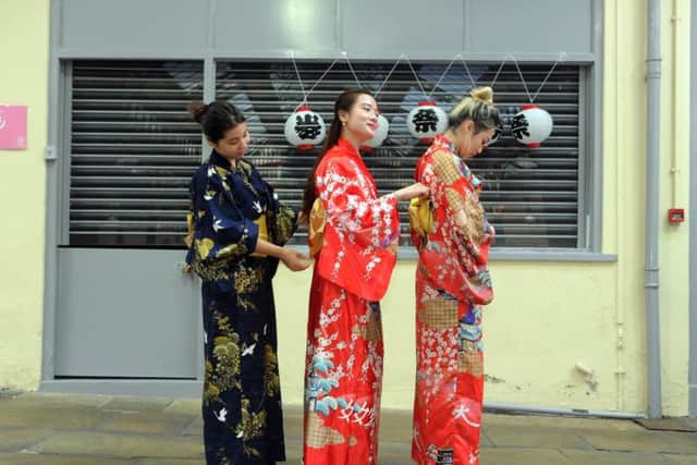 Leeds University students Helena da Costa, Louisa Luong and Mia Huffman dress in traditional Japanese kimono's at the third Sakura Japanese Cultural Festival, a special pop-up experience in Leeds Market on 8 June 2019