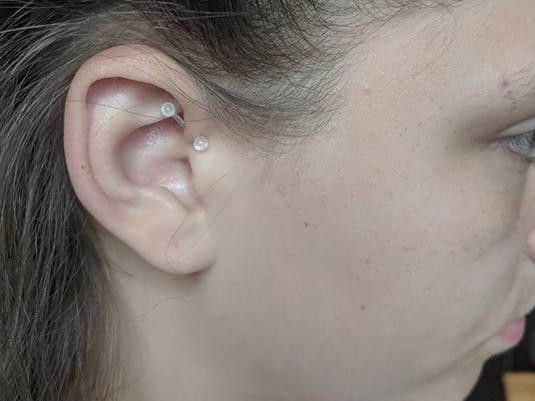 Bobbie-May Smith was sent home from John Charles Academy for wearing this plastic earring to combat her migraines