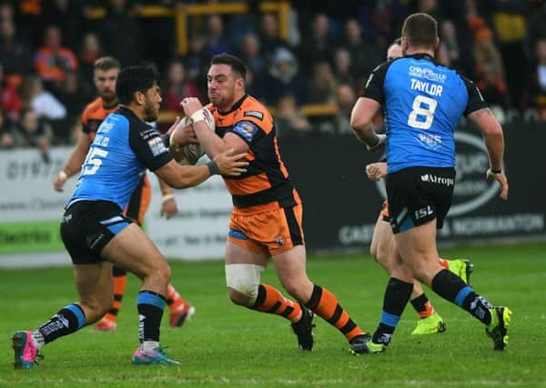 Grant Millington is tackled by Hull's Andre Savelio.