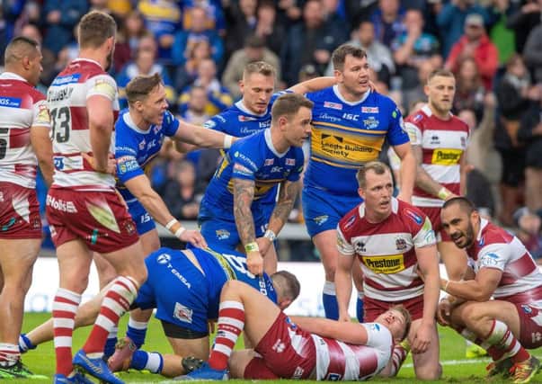 Adam Cuthbertson gathers himself up from the ground after scoring Leeds Rhinos' first try against Wigan. Picture: Bruce Rollinson