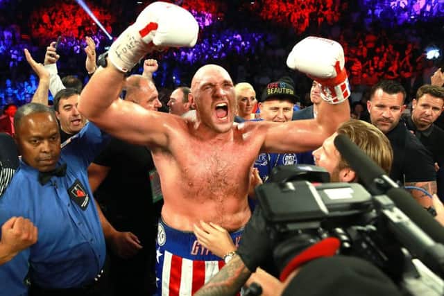 Victory roar: Tyson Fury celebrating his second-round victory over Germany's Tom Schwarz. Pictures:: Mikey Williams/Top Rank/PA