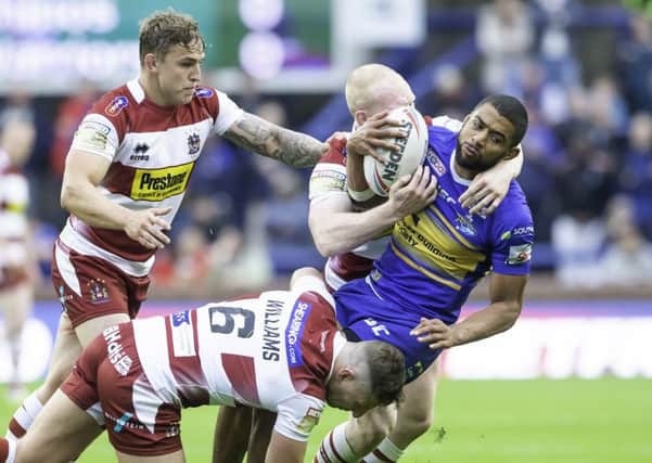 On his way:  Leeds Rhinos star Kallum Watkins is tackled by Wigan's George WIlliams and Liam Farrell. Picture: Allan McKenzie/SWpix