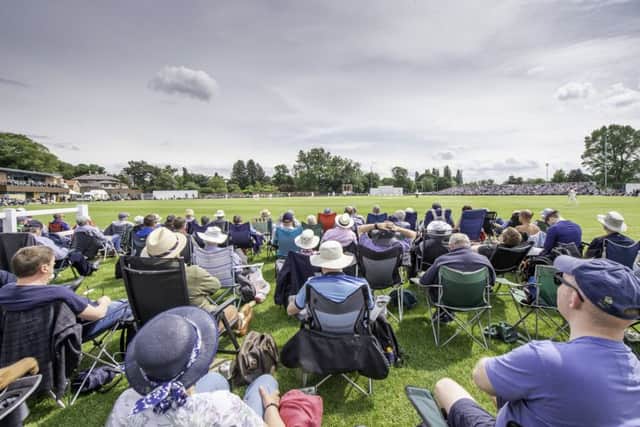Supporters watch on as Yorkshire play Warwickshire at York's Clifton Park Cricket Club.