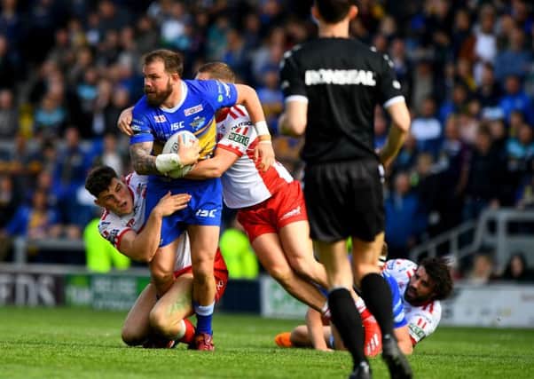 LOOKING UP: Leeds Rhinos' Adam Cuthbertson is tackled to the ground against Hull KR. Picture: James Hardisty.
