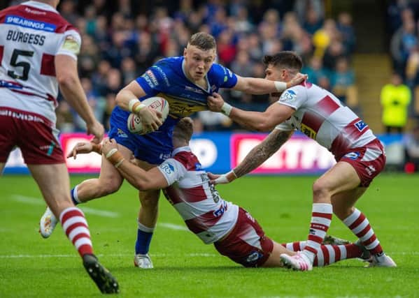 Harry Newman is held by Wigan's George Williams and Oliver Gildart at Headingley last week. PIC: Bruce Rollinson/JPIMedia