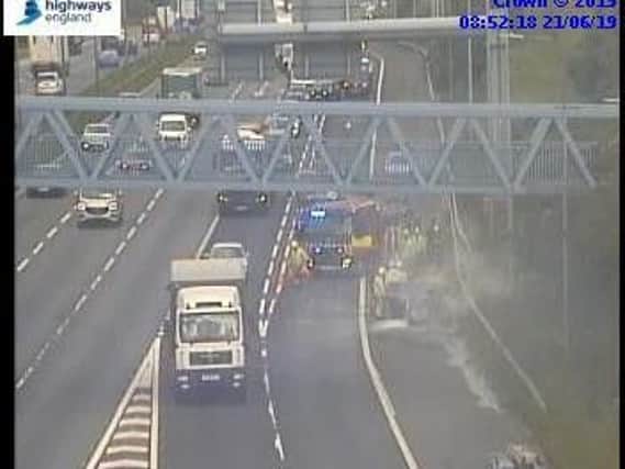 Fire crews attending a car fire on the M62. Photo: Highways England.