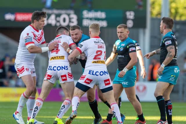 Leeds Rhinos' Brad Singleton is held by St Helens' Mark Parcival and Aaron Smith during Friday night's defeat.
 Picture: Bruce Rollinson