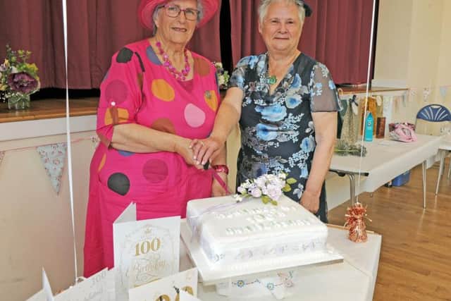 Meanwood Women's Institute President Joan Webster and the chair of the West Yorkshire Federation  Rosemary Pearson, cut a home-made cake to celebrate their 100th anniversary with a vintage tea party at Holy Trinity Community Hall in Leeds.