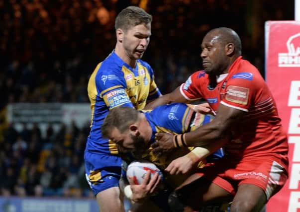 Robert Lui tries to prevent Leeds Rhinos' Adam Cuthbertson touching down as Matt Parcell looks on. Picture Bruce Rollinson