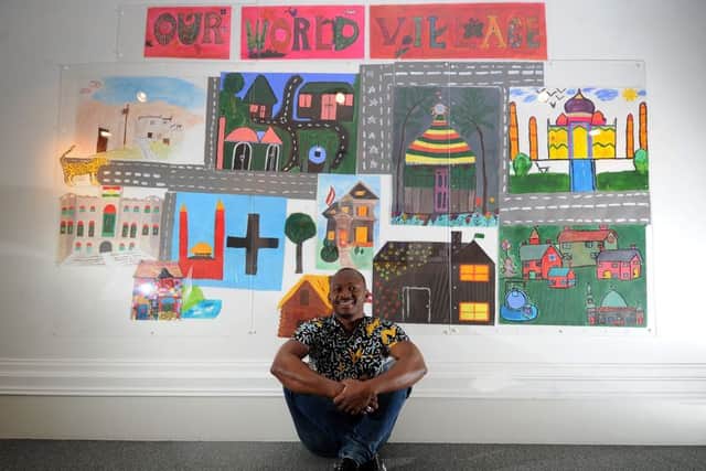 EXPRESSION: Artist Ousmane Batebou pictured with some of his art at the exhibition.