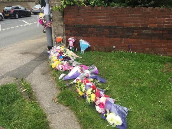 Flowers left at the scene in East Ardsley.