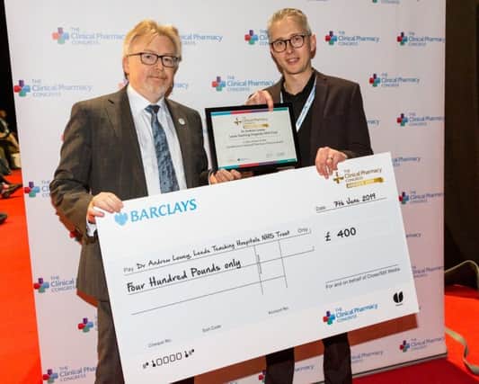Chief pharmaceutical officer for England (left), Keith Ridge, presenting Dr Andrew Lowey with his award