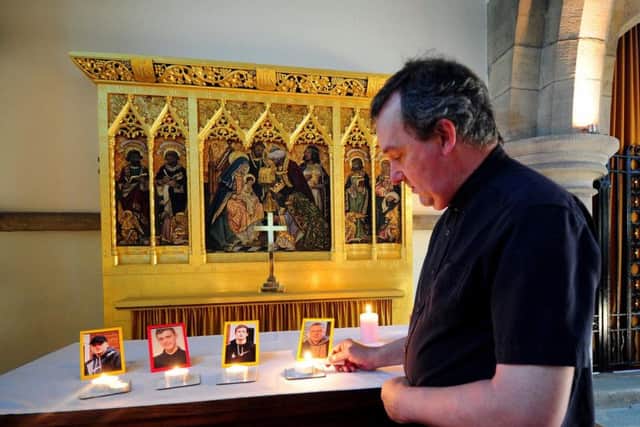 Rev Nigel Sinclair lights a candle for the victims of the Horsforth car cash at St Margarets Church in July 2018
