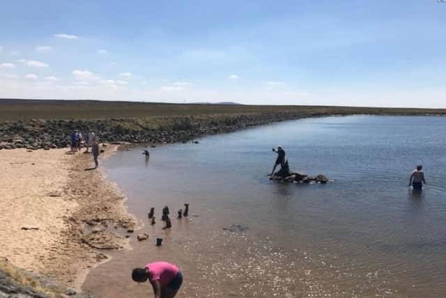 There's a strip of sand and some water to paddle in at Gaddings Dam. Photo: Johnny Clarke