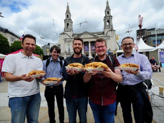 Tourists from Germany are pictured with fish and chips at the festival. Picture by Simon Hulme.