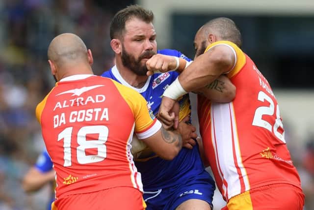 Adam Cuthbertson is tackled by Catalans' Alrix Da Costa and Sam Kasiano.