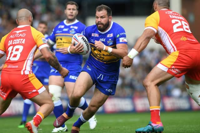 Adam Cuthbertson is tackled by Catalans Dragons' Alrix Da Costa and Sam Kasiano.