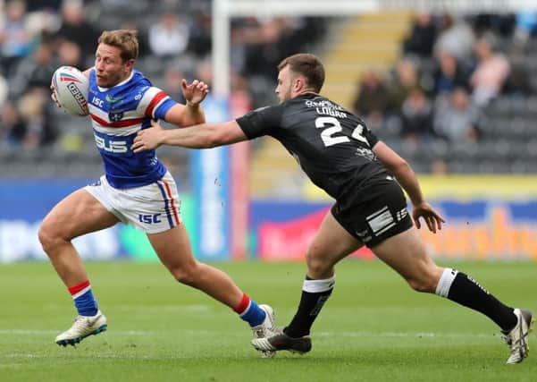 Kyle Wood, left, gets away from Jack Logan of Hull FC.