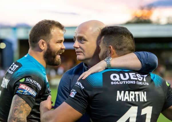 Richard Agar embraces Rhyse Martin and Adam Cuthbertson after victory over Castleford.