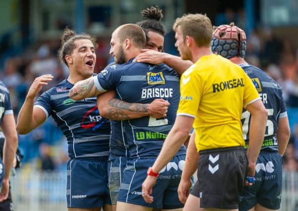 Featherstone Rovers players celebrate Luke Briscoe's try against Leigh Centurions. Picture: James Heaton
