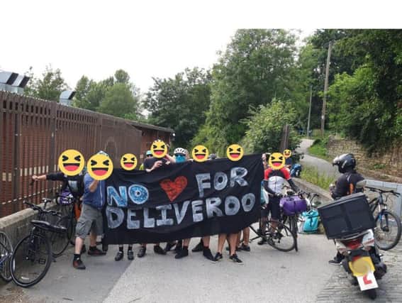 Deliveroo couriers, with face covered to protect their identities, outside the Scott Hall Mills industrial complex.