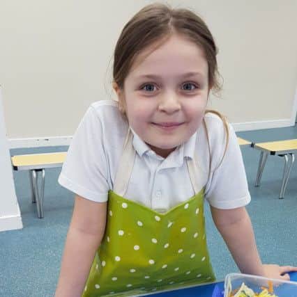 A young girl cooks up a treat with Flourishing Families Leeds.