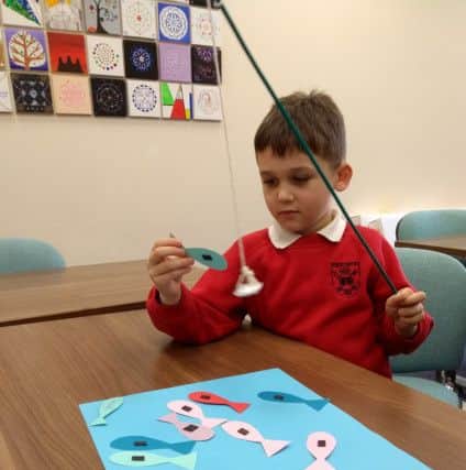 A little boy 'goes fishing' at one of Flourishing Families Leeds craft groups.