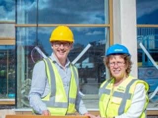 James Brining (Leeds Playhouse) and Coun Judith Blake (LCC) holding one of the new tiles from the new extension at Leeds Playhouse. Picture by Anthony Robling