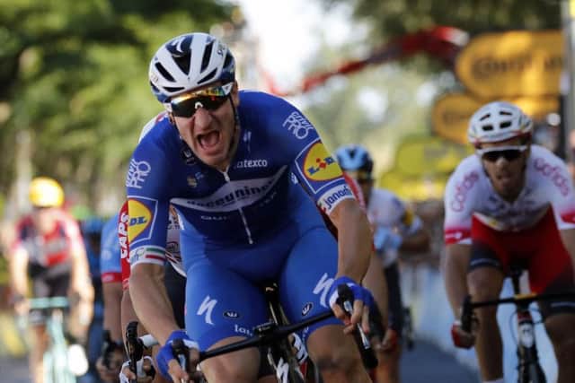 Italy's Elia Viviani celebrates as he crosses the finish line to win the fourth stage of the Tour de France. Picture: AP/Christophe Ena