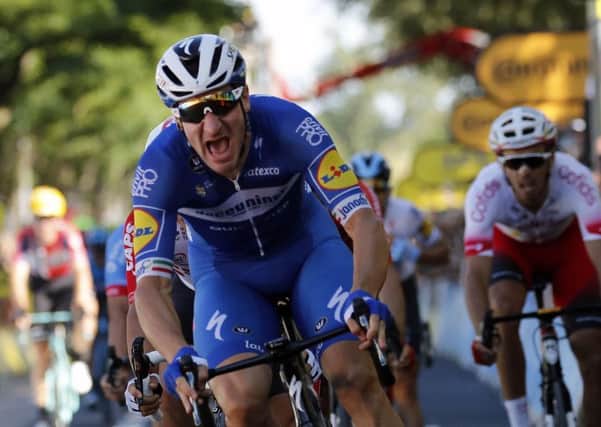 Italy's Elia Viviani celebrates as he crosses the finish line to win the fourth stage of the Tour de France. Picture: AP/Christophe Ena
