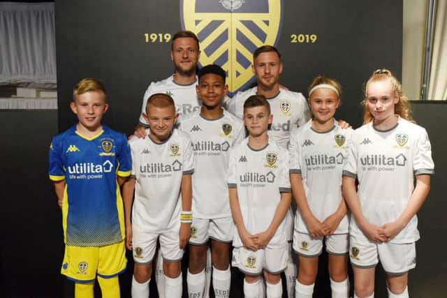 ALL NEW: Skipper Liam Cooper, back left, and defender Barry Douglas, back right, model the new Leeds United home kit.