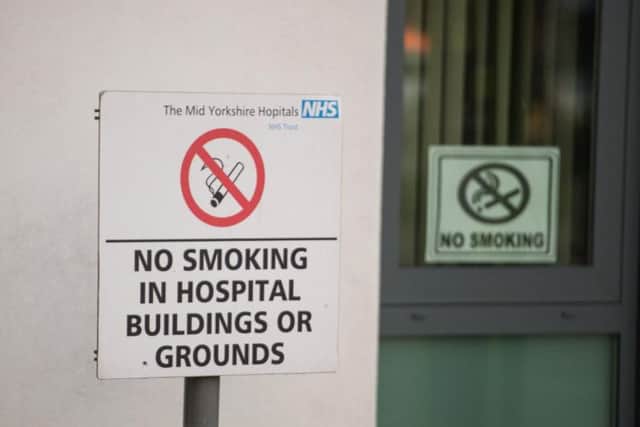 A sign banning smoking on hospital grounds. (Credit: SWNS)