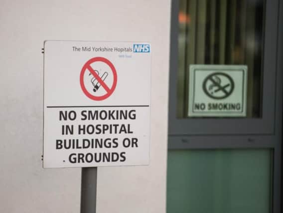 A sign banning smoking on hospital grounds. (Credit: SWNS)