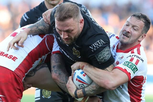 Josh Griffin of Hull FC is tackled by Ben Crooks and Danny McGuire of Hull KR.